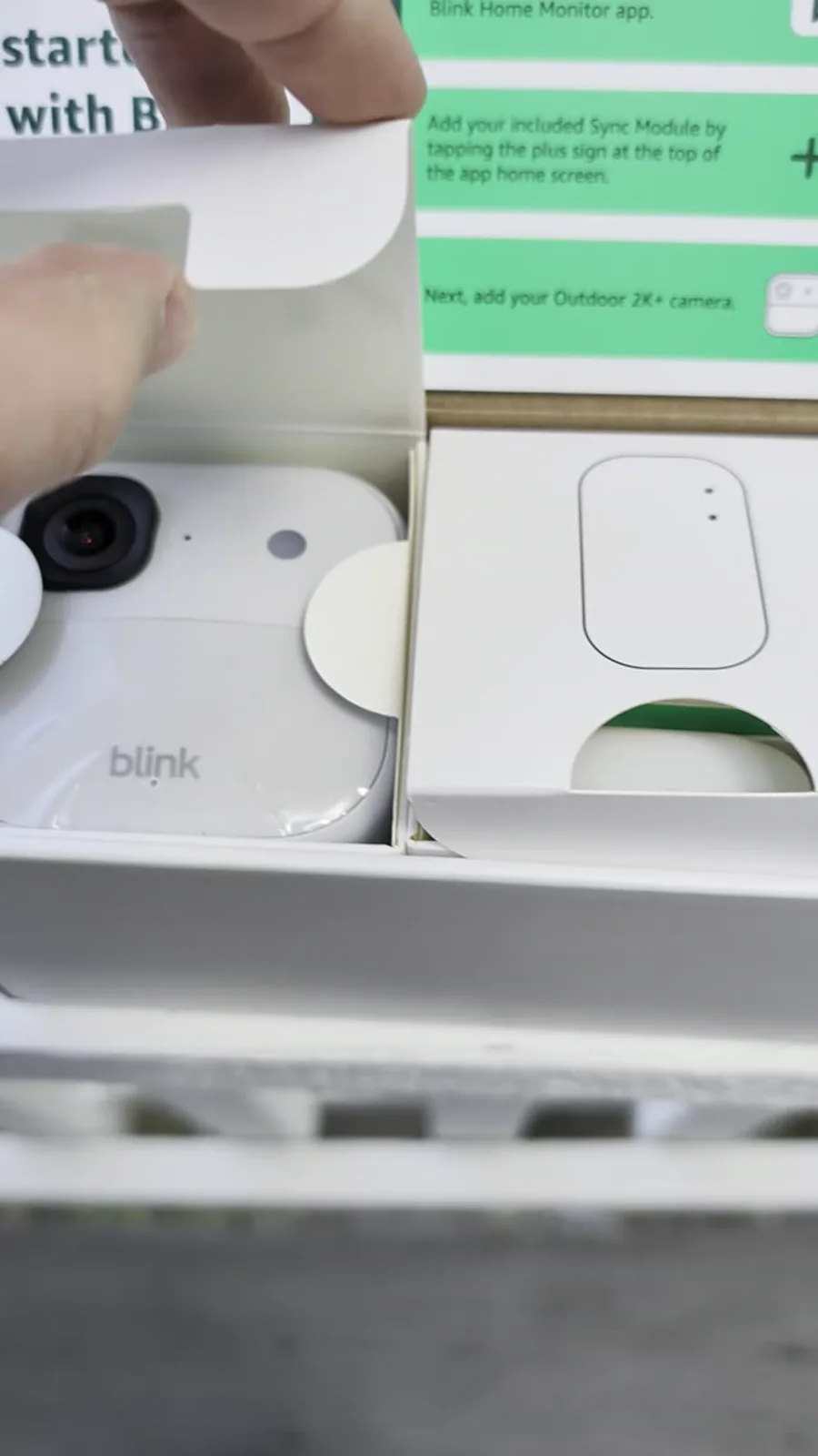 Blink Outdoor 2K+ camera and Sync Module Core inside the opened retail box